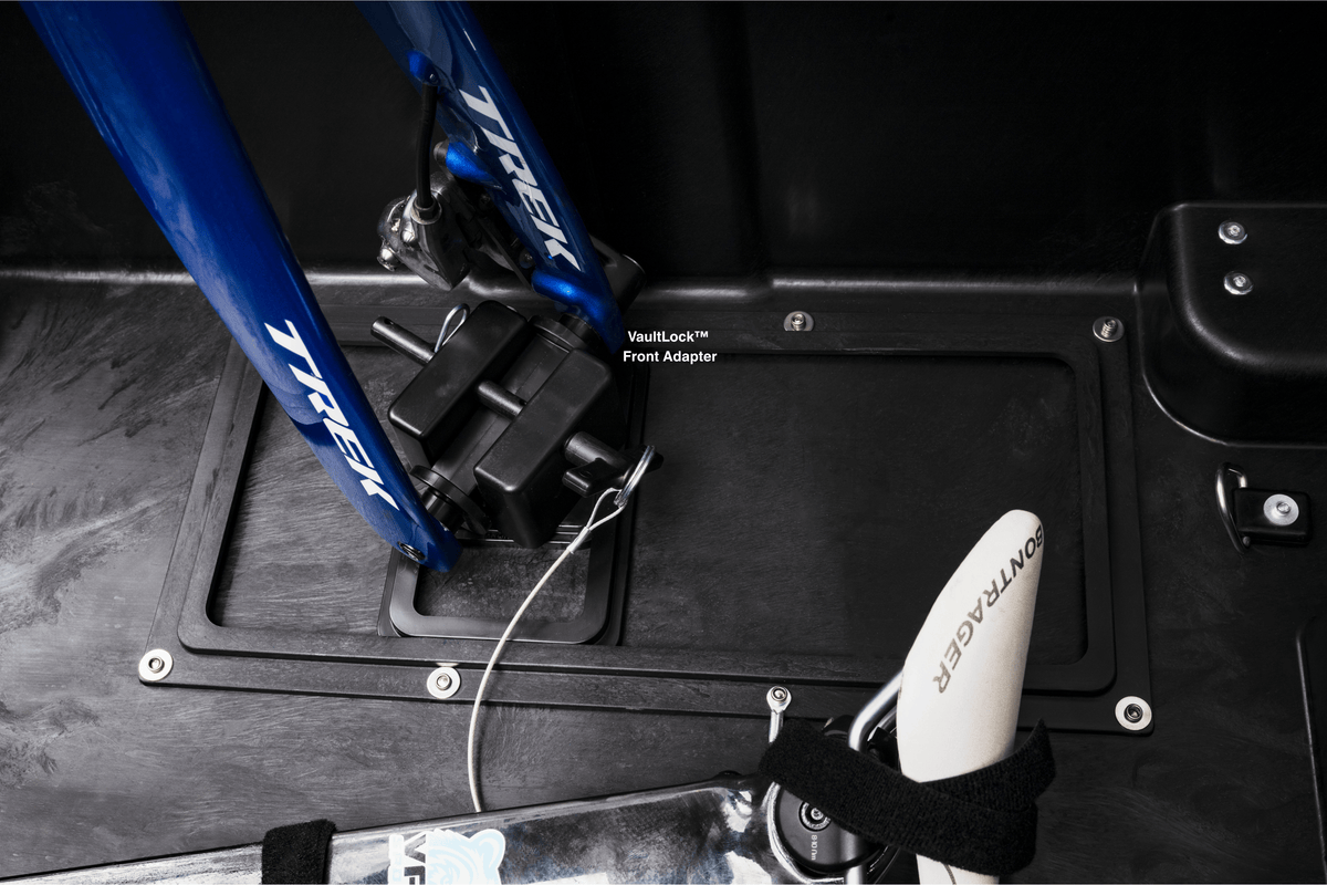 Close-up inside the case: the fork of a blue bike mounted on the VaultLock front adapter.