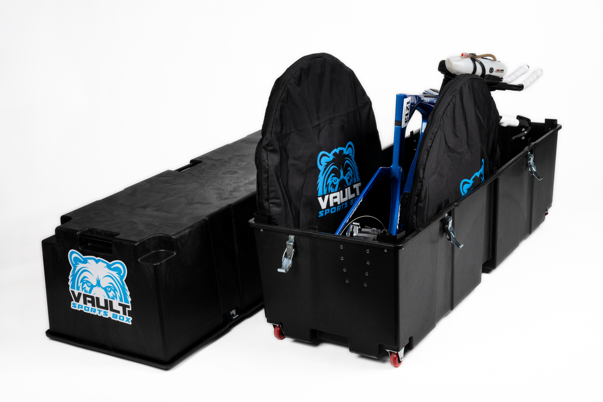 Vault Pro bike box open with a bike loaded and its wheels stowed in a Vault-branded wheel bag.